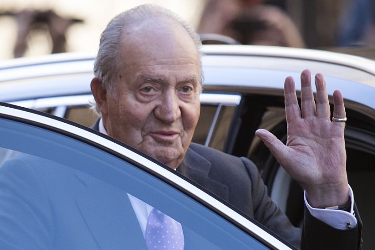 (FILES) In this file photo taken on April 01, 2018 Former King Juan Carlos I of Spain waves as he leaves after attending the traditional Easter Sunday Mass of Resurrection in Palma de Mallorca on Apri