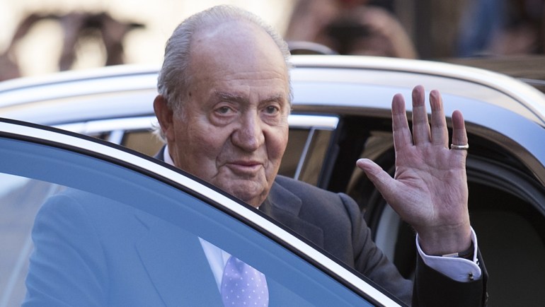 (FILES) In this file photo taken on April 01, 2018 Former King Juan Carlos I of Spain waves as he leaves after attending the traditional Easter Sunday Mass of Resurrection in Palma de Mallorca on Apri