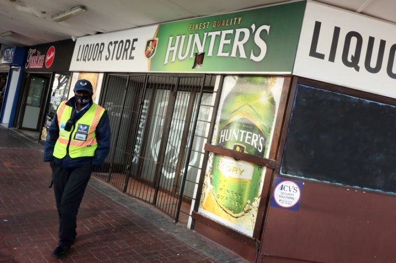 A security guard stands outside a liquor store closed under the coronavirus disease (COVID-19) lockdown regulations in Cape Town