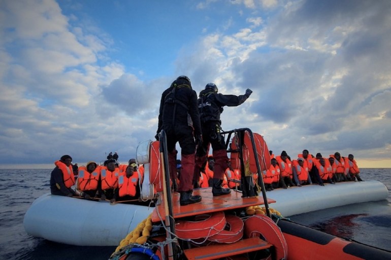 Migrants wearing lifejackets on a rubber dinghy are pictured during a rescue operation by the MSF-SOS Mediterranee run Ocean Viking rescue ship, off the coast of Libya in the Mediterranean