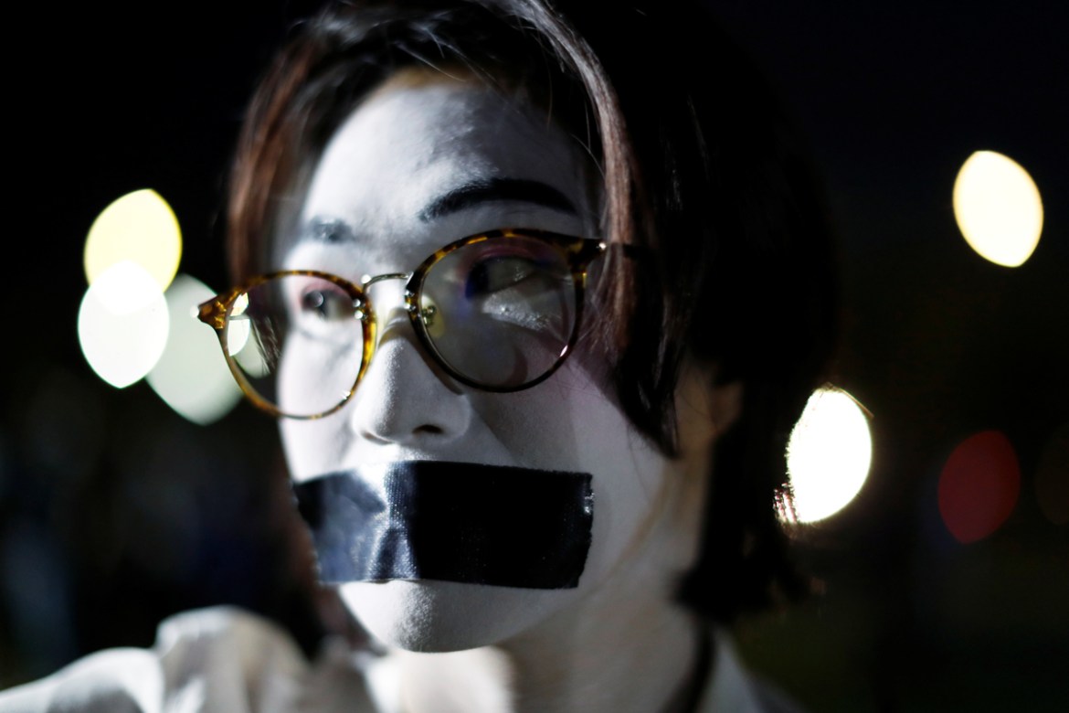 A pro-democracy student with taped mouth and make-up attends a rally to demand the government to resign, to dissolve the parliament and to hold new elections under a revised constitution, at Mahidol U