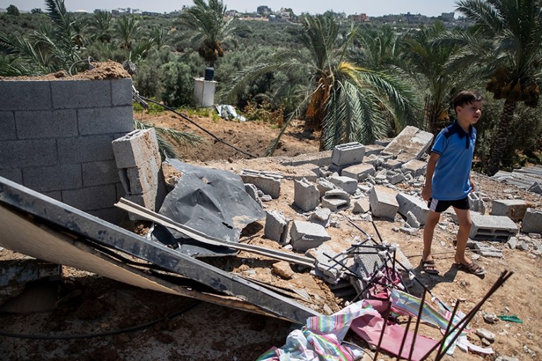 A Palestinian boy inspects the damage in his family home following Israeli airstrikes in Buriej refugee camp, central Gaza Strip, Saturday, Aug. 15, 2020. (AP Photo/Khalil Hamra)