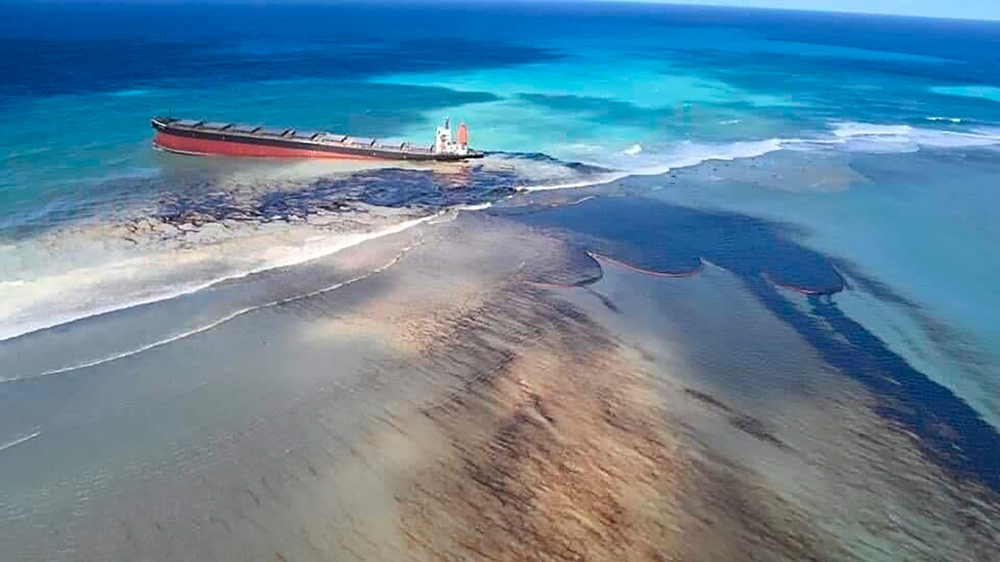 This photo taken and provided by Georges de La Tremoille of Mu Press shows oil leaking from the MV Wakashio, a bulk carrier ship that recently ran aground off the southeast coast of Mauritius, Friday,