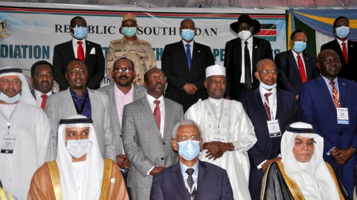 Delegates pose for a photograph during the signing of a peace agreement between Sudan''s power-sharing government and five key rebel groups, a significant step towards resolving deep-rooted conflicts t