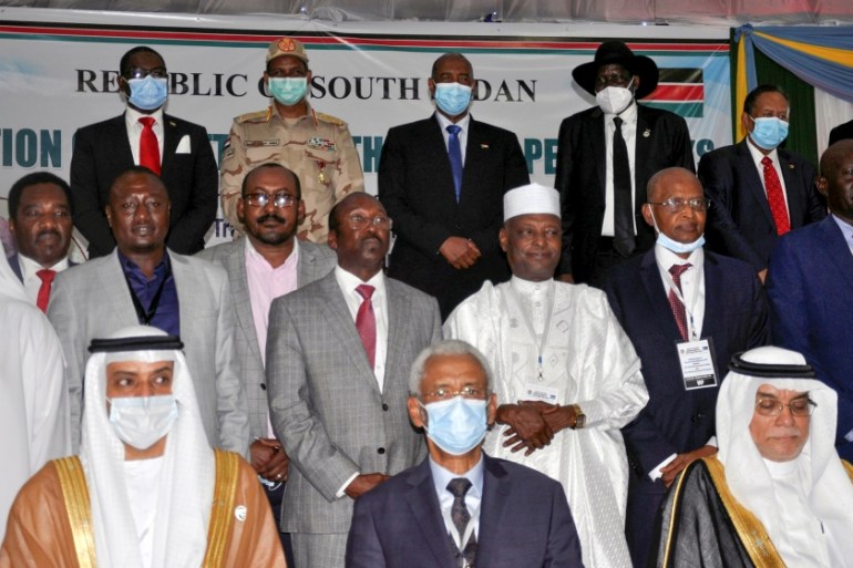Delegates pose for a photograph during the signing of a peace agreement between Sudan''s power-sharing government and five key rebel groups, a significant step towards resolving deep-rooted conflicts t