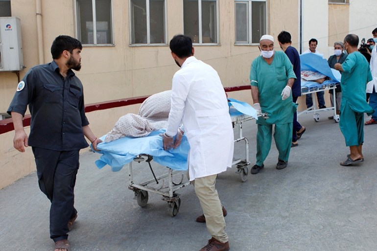 Hospital workers transfer injured people for treatment after a truck bomb blast in Balkh province, in Mazar-i-Sharif, Afghanistan August 25, 2020. REUTERS/Stringer NO RESALES. NO ARCHIVES.