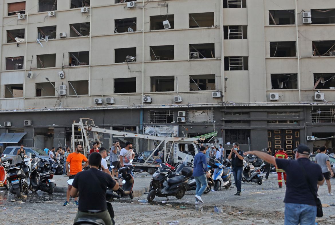 People gather near the scene of an explosion in Beirut on August 4, 2020. - A large explosion rocked the Lebanese capital Beirut today, an AFP correspondent said. The blast, which rattled entire build