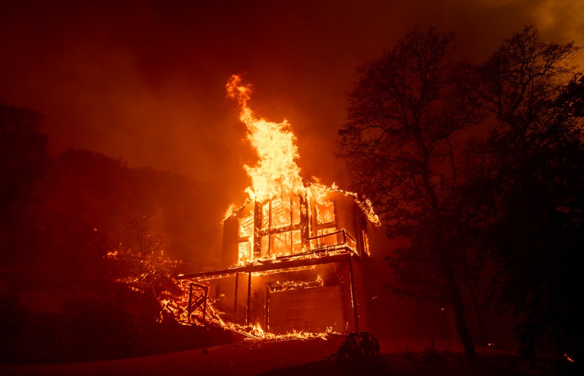 A home burns in the Spanish Flat area of Napa, California as flames rage through on August 18, 2020. - As of the late hours of August 18, the Hennessey fire has merged with at least 7 fires and is now