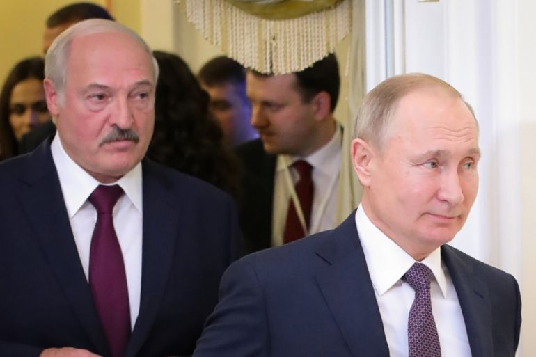 (FILES) This file photo taken on December 20, 2019 shows Russian President Vladimir Putin (R) followed by Belarusian President Alexander Lukashenko (L), entering a meeting hall