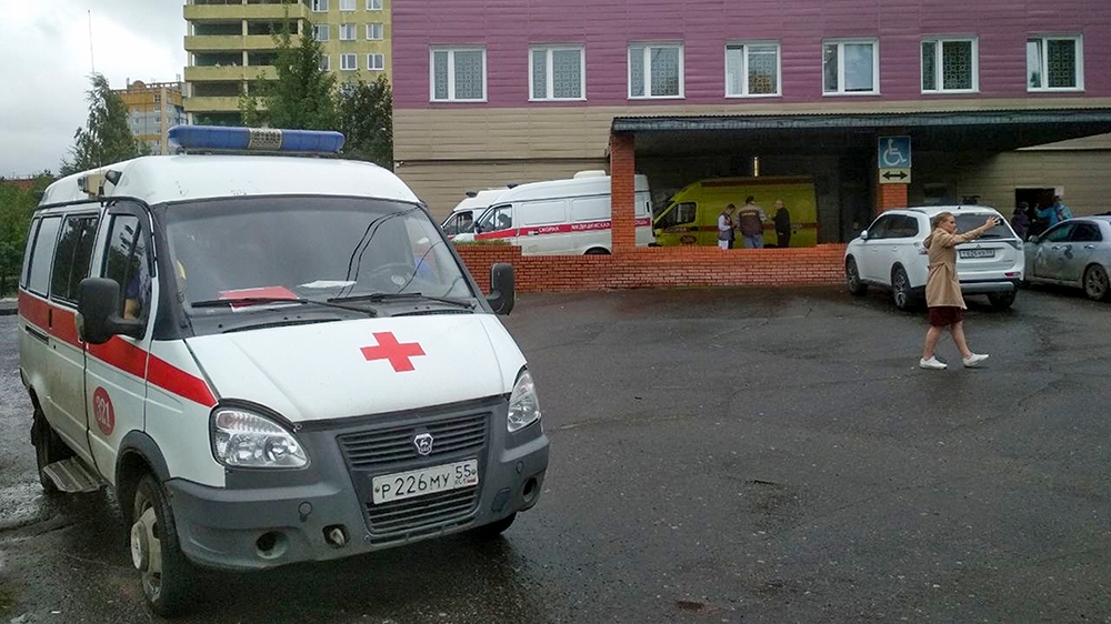 An ambulance parked next to a building of a hospital intensive care unit where Alexei Navalny was hospitalized in Omsk, Russia, Thursday, Aug. 20, 2020. Russian opposition politician Alexei Navalny is