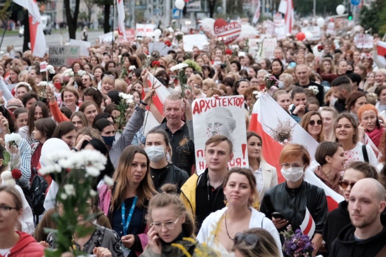 Women attend a demonstration against police brutality following recent protests to reject the presidential election results in Minsk