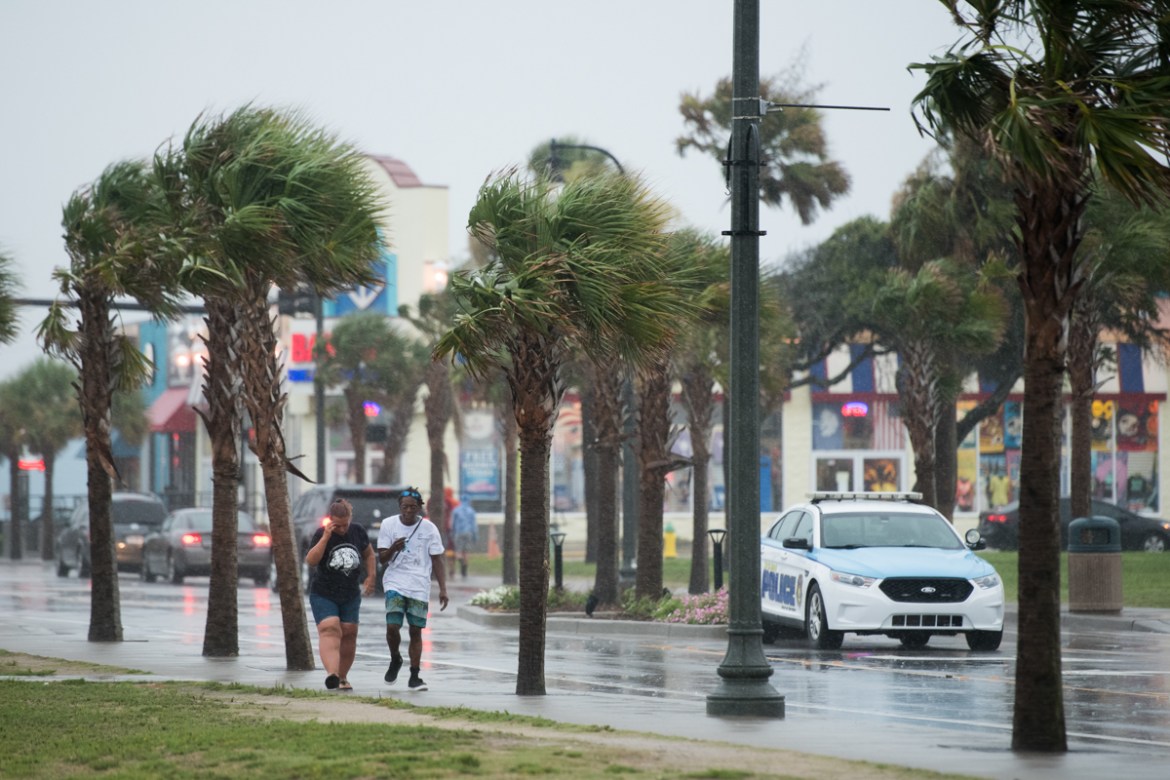 MYRTLE BEACH, SC - AUGUST 3: People walk along Ocean Boulevard in the rain August 3, 2020 in Myrtle Beach, South Carolina. Hurricane Isaias continued to move north along the U.S. eastern seaboard. (Ph