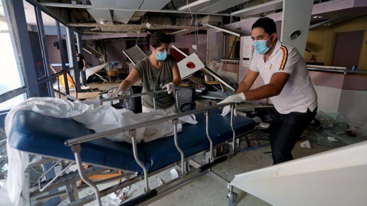 People wearing face masks move a gurney at a damaged hospital following Tuesday''s blast in Beirut, Lebanon August 5, 2020. REUTERS/Mohamed Azakir