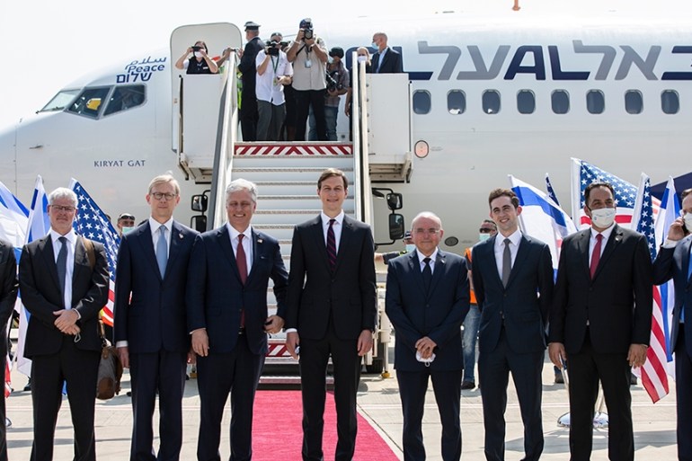 U.S. Presidential Adviser Jared Kushner (C-R) and National Security Adviser Robert OBrien(C-L) pose with members of the US-Israeli delegation to the UAE following a normalisation accord, as they prepa