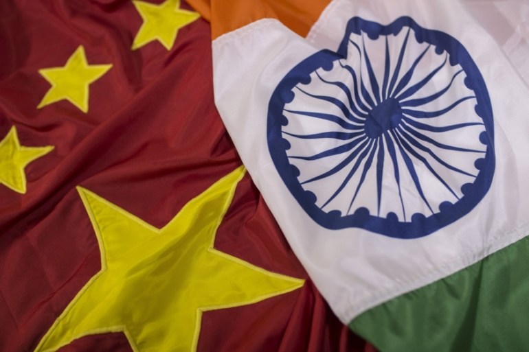 India, China flags [Bloomberg]