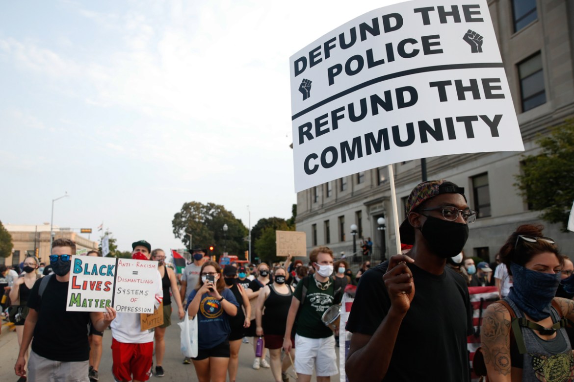 Protesters march to demonstrate against the shooting of Jacob Blake who was shot in the back multiple times by police the day before, prompting community protests in Kenosha, Wisconsin on August 24, 2