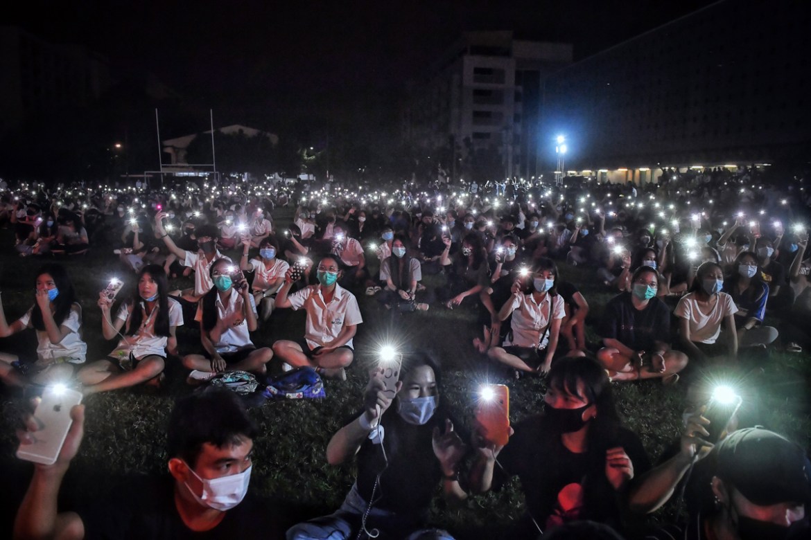 Students use their mobile phones as flashlights at an anti-government rally at Mahidol University in Nakhon Pathom on August 18, 2020. - The country has seen near-daily protests in recent weeks by uni