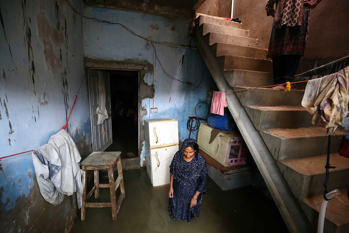 epa08624503 A woman stands in her house after heavy rains in Karachi, Pakistan, 25 August 2020. Heavy monsoon rain flooded several areas of Karachi causing traffic jams and power outages. EPA-EFE/SHA