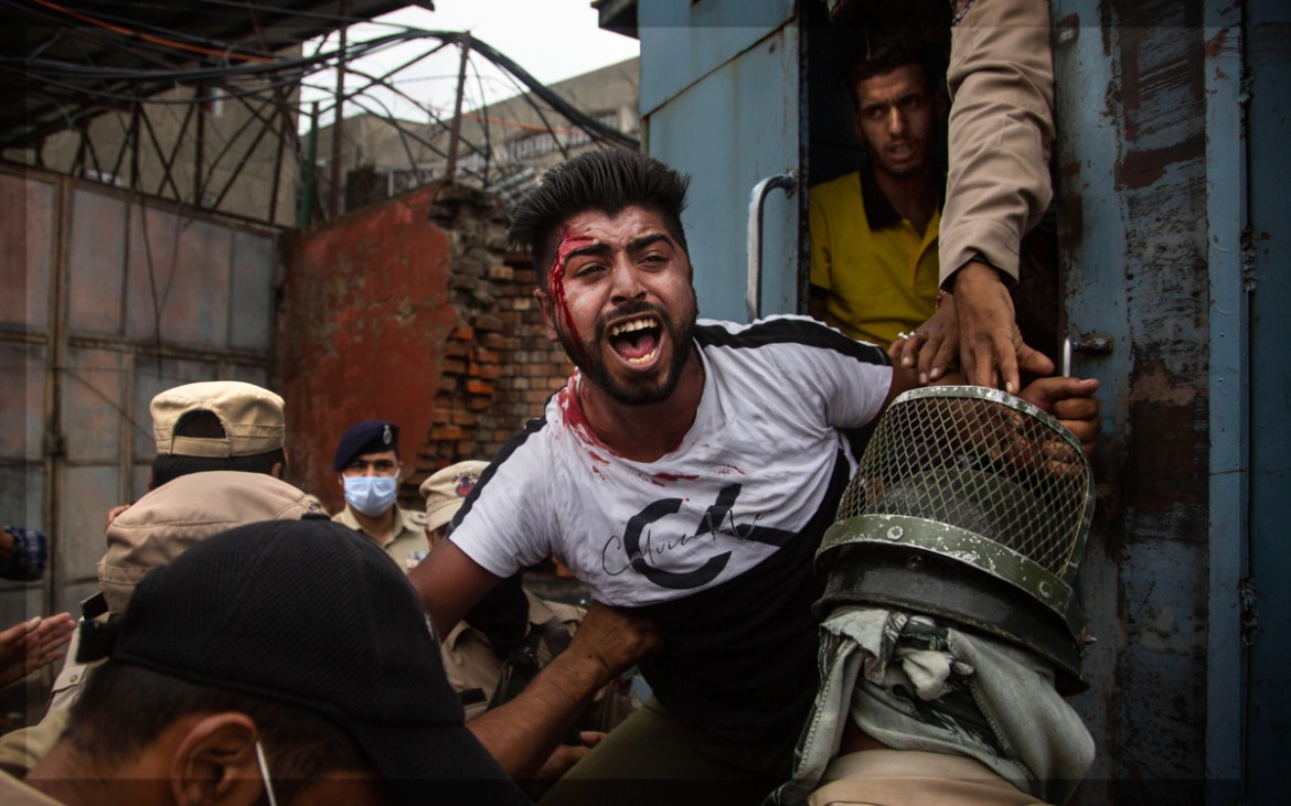 Indian policemen detain a Kashmiri Shiite Muslim as he attempt with others to take out a religious procession in Srinagar, Indian controlled Kashmir, Friday, Aug. 28, 2020. Police and paramilitary sol