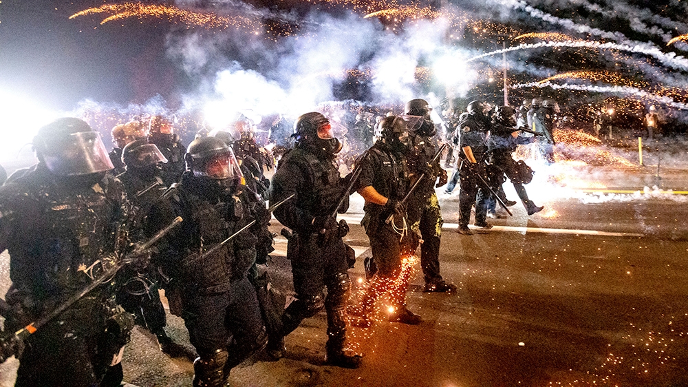 Police use chemical irritants and crowd control munitions to disperse protesters during a demonstration in Portland, Ore., Saturday, Sept. 5, 2020. Hundreds of people gathered for rallies and marches 