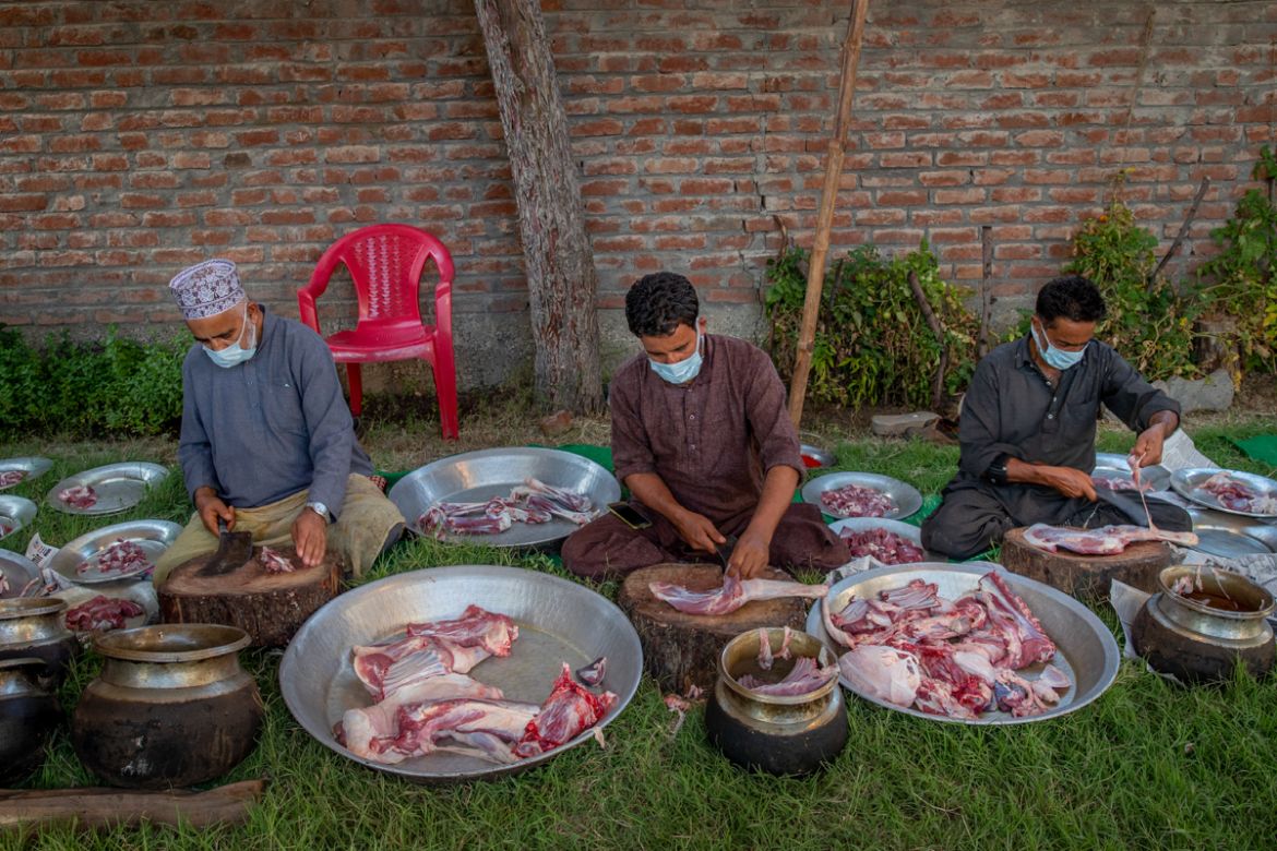 Kashmiri Wazas, or chefs, chop mutton before cooking for a wedding feast Wazwan on outskirts of Srinagar, Indian controlled Kashmir, Tuesday, Sept. 16, 2020. The coronavirus pandemic has changed the w