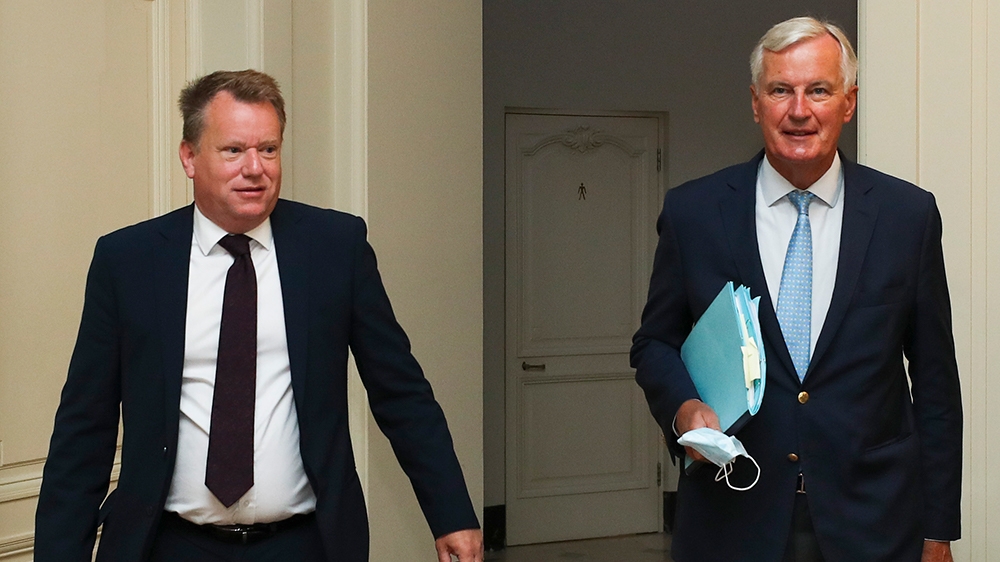 European Union chief Brexit negotiator Michel Barnier, right, and the British Prime Minister's Europe adviser David Frost arrive for Brexit trade talks between the EU and the UK, in Brussels, Friday, 