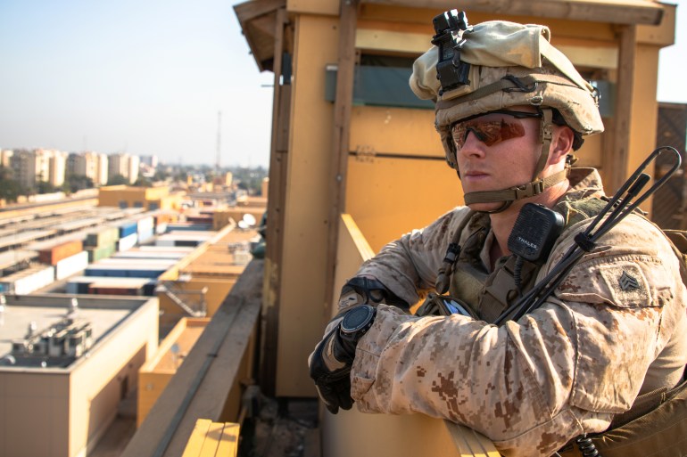 A U.S. Marine with 2nd Battalion, 7th Marines, assigned to the Special Purpose Marine Air-Ground Task Force-Crisis Response-Central Command (SPMAGTF-CR-CC) 19.2, supervises his squad as they provide over watch security at the U.S. embassy compound in Baghdad, Iraq, January 3, 2020.