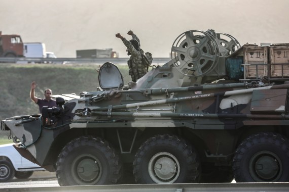 People in Azerbaijan's capital, Baku greet, military personnel in an armoured carrier [Aziz Karimov/Reuters]