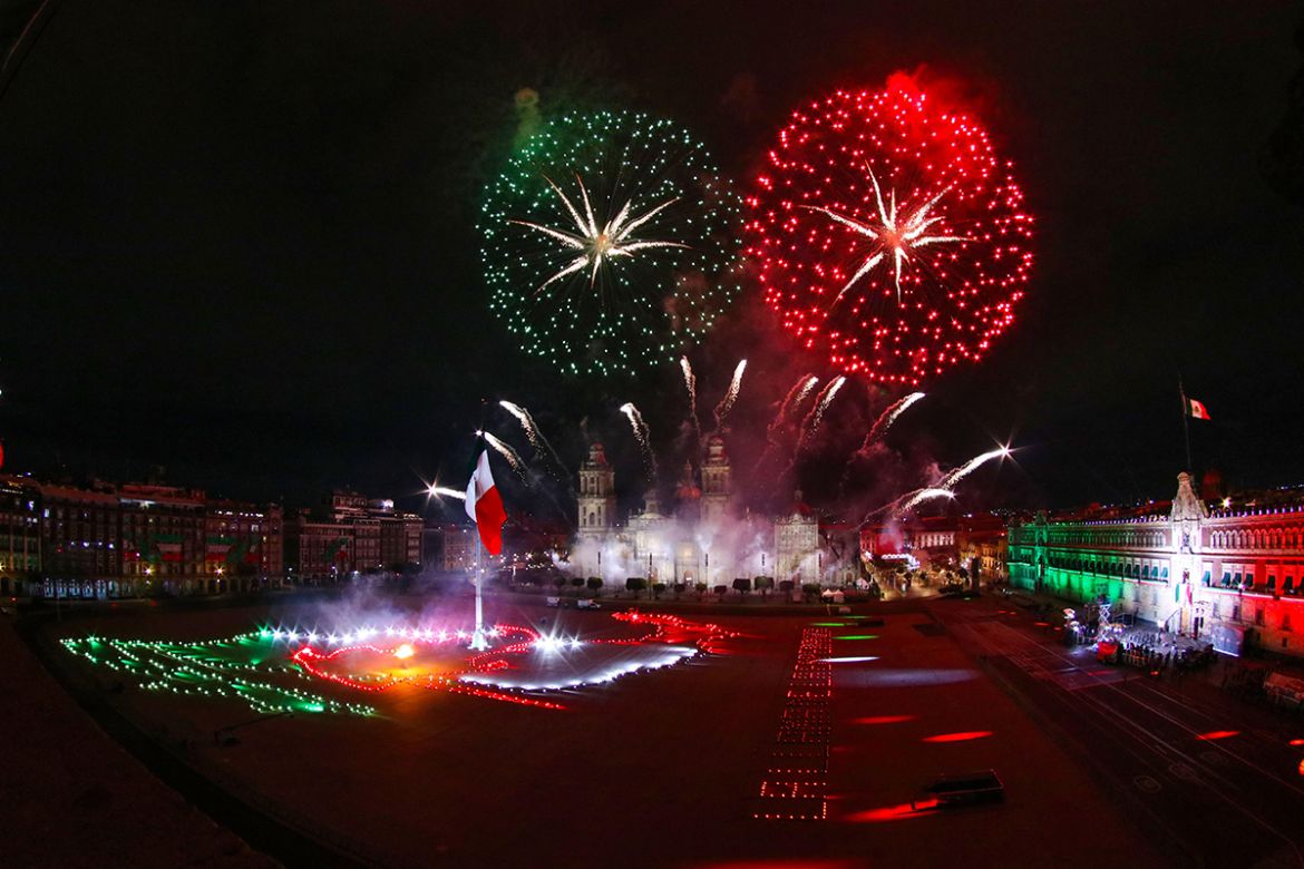 epa08672021 Fireworks expode over Zocalo Square during the ceremony of the Cry of Dolores, at the National Palace in Mexico City, Mexico, 15 September 2020. Lopez Obrador celebrated an unprecedented C