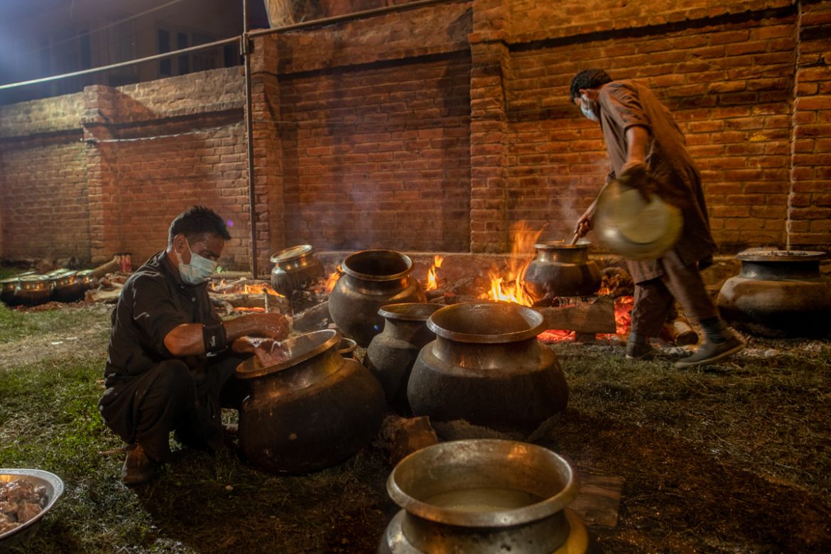 Kashmiri Wazas, or chefs, cook for a wedding feast Wazwan, on the outskirts of Srinagar, Indian controlled Kashmir, Tuesday, Sept. 16, 2020. The coronavirus pandemic has changed the way people celebra