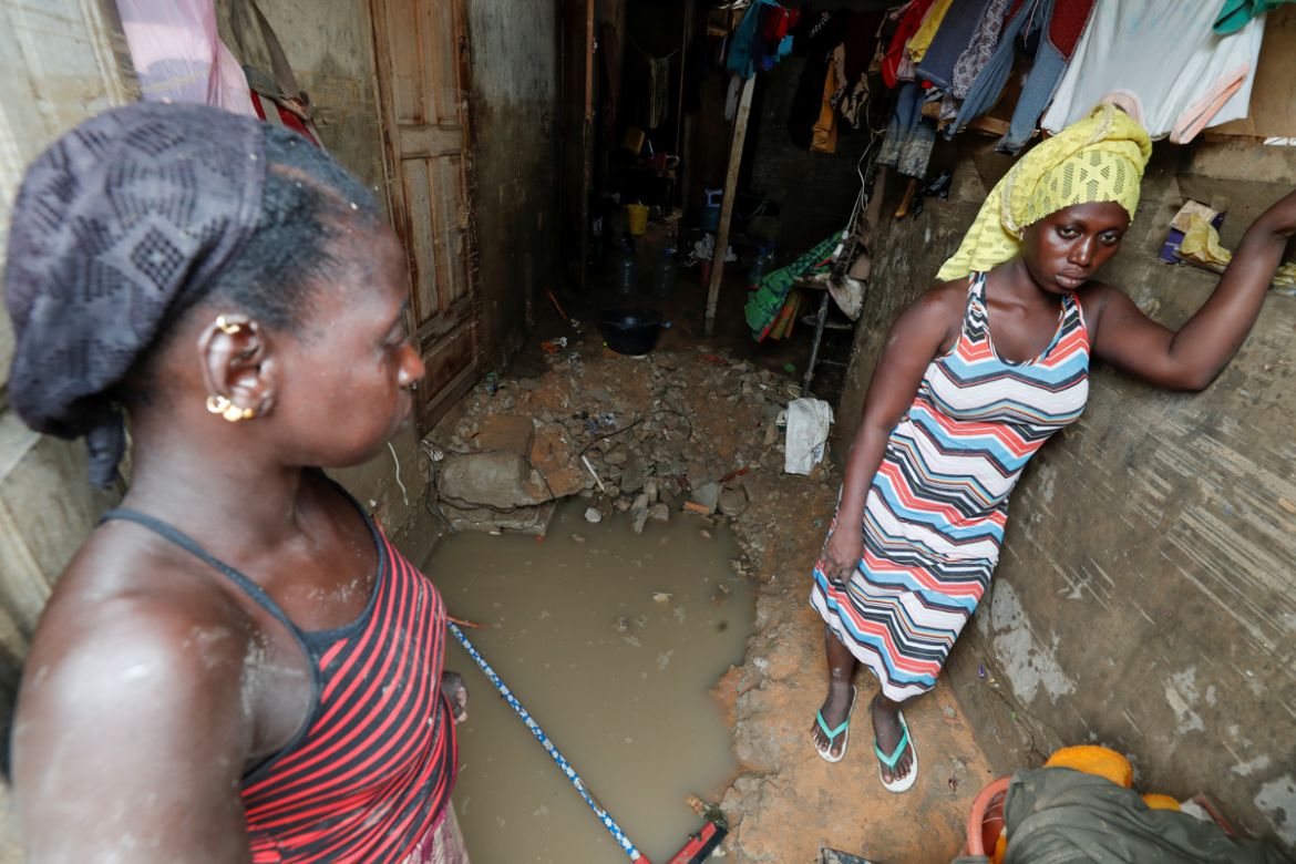 Women stand at the entrance of their flooded house after heavy rains in the Ndiaga Mbaye district on the outskirts of Dakar, Senegal September 6, 2020.REUTERS/ Zohra Bensemra