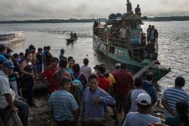 Passengers arrive in a public taxi boat to the Shipibo Indigenous community of Pucallpa, located along the Ucayali River in the Amazonian rainforest of eastern Peru, Thursday, Sept. 3, 2020, amid the