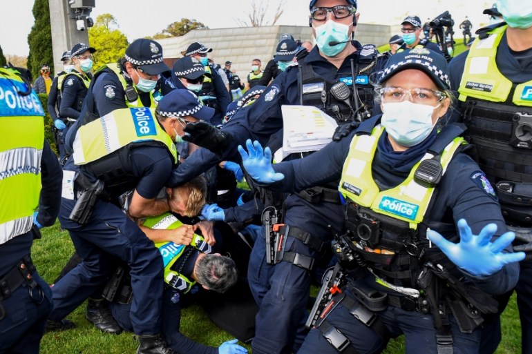 Police tackle protesters in Melbourne