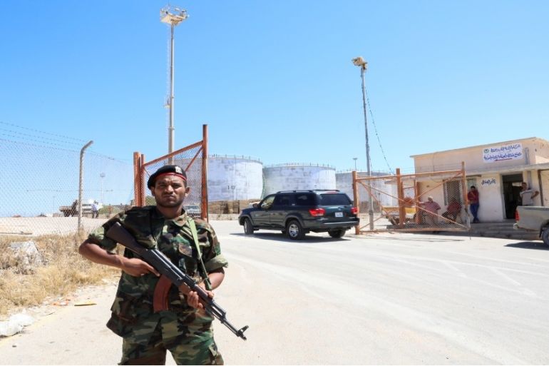 File: A member of the Petroleum Facilities Guard is seen at the entrance of Azzawiyah Oil Refinery, in Zawiyah, Libya