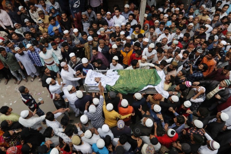 People carry the body of Hashim Ali, who was wounded on Tuesday in a clash between people demonstrating for and against