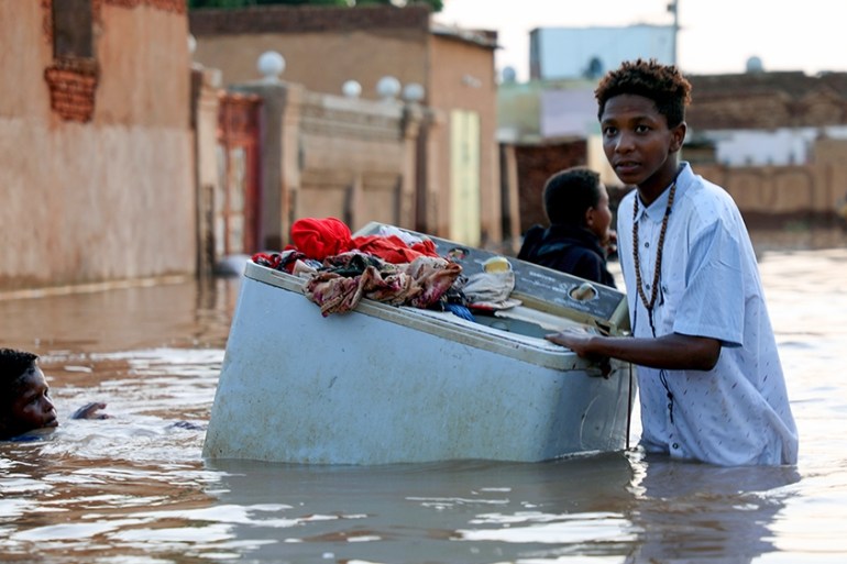 Some residents carry their belongings and take them out of their homes amid the severe flooding in the Umm Dum area, east of Khartoum, Sudan, 08 September 2020. The Nile?s flooding usually