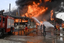 epa08658477 Lebanese firefighters try to extinguish a fire at a Port of Beirut, Lebanon, 10 September 2020. A massive fire is raging at the port of Beirut, a little more than a month after a huge expl