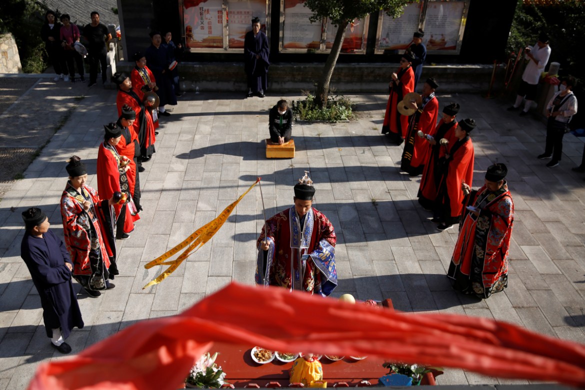 The widow of Liu, 42, attends a memorial ceremony to see her late husband''s tablet on the day of Hungry Ghost Festival, at Taoist temple Jiuyang Palace, in Laiwu of Jinan city, Shandong province, Chin