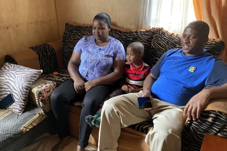 Five-year-old Miguel Munene sits between his parents Patrick Nyaga and Celestine Wanjiru, as he watches characters from a cartoon made by Tanzanian non-profit Ubongo, which offers television and radio
