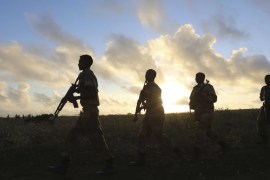 Somali army soldiers make their way to the town of Barawe at dawn during the second phase of Operation Indian Ocean