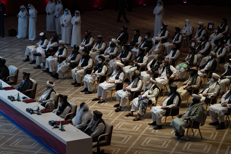 Delegates attend talks between the Afghan government and the Taliban in Doha [Sorin Furcoi/Al Jazeera]