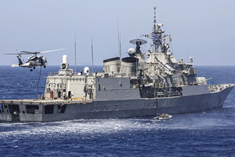 A handout photo released by the Greek National Defence Ministry on August 26, 2020 shows Greek Hydra-class frigate Psara (F-454) of the Hellenic Navy and a military helicopter taking part in a militar