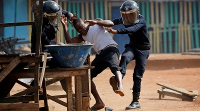 Policemen detain a demonstrator during a protest against president Alassane Ouattara's decision to stand for a third term, in Abidjan, Ivory Coast, August 13, 2020. REUTERS/Luc Gnago 