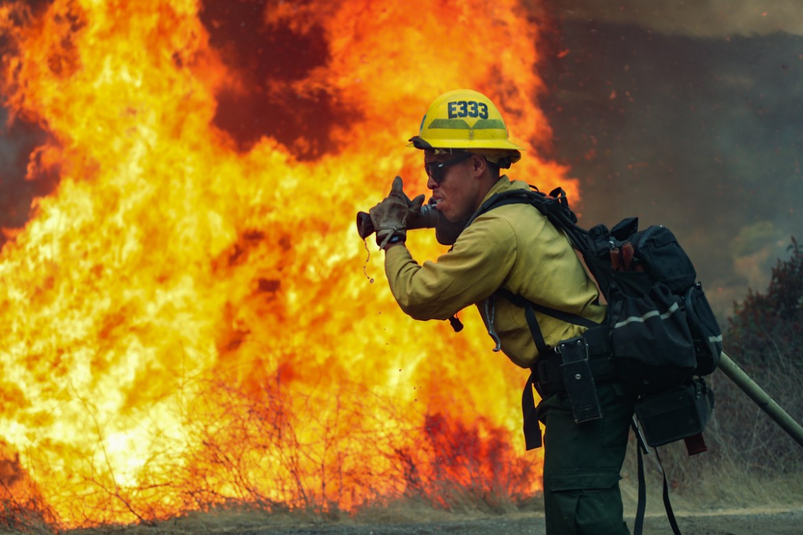 San Miguel County Firefighters battle a brush fire along Japatul Road during the Valley Fire in Jamul, California on September 6, 2020 - The Valley Fire in the Japatul Valley burned 4,000 acres overni