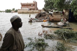 A man walks beside a flooded road in the town of Shaqilab, about 15 miles (24 kilometers) southwest of the capital, Khartoum, Sudan, Monday, Aug. 31, 2020. (AP Photo/Marwan Ali)