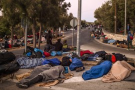 Migrants sleep on the ground as they spend the night on a road near Mytilene after a fire destroyed Greece''s largest Moria refugee camp on the island of Lesbos, early on September 10, 2020. Greek auth