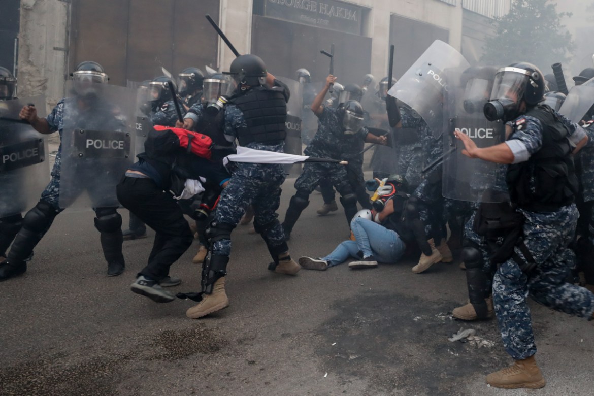 Riot policemen beat anti-government protesters during a protest near Parliament Square, in Beirut, Lebanon, Tuesday, Sept. 1, 2020. On a visit to Lebanon, French President Emmanuel Macron issued a ste