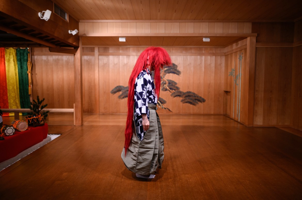 This photo taken on July 29, 2020 shows performer Kennosuke Nakamori posing with a red wig, or "akagashira", after an interview with AFP at the Kamakura Noh Theatre in the town of Kamakura in Kanagawa