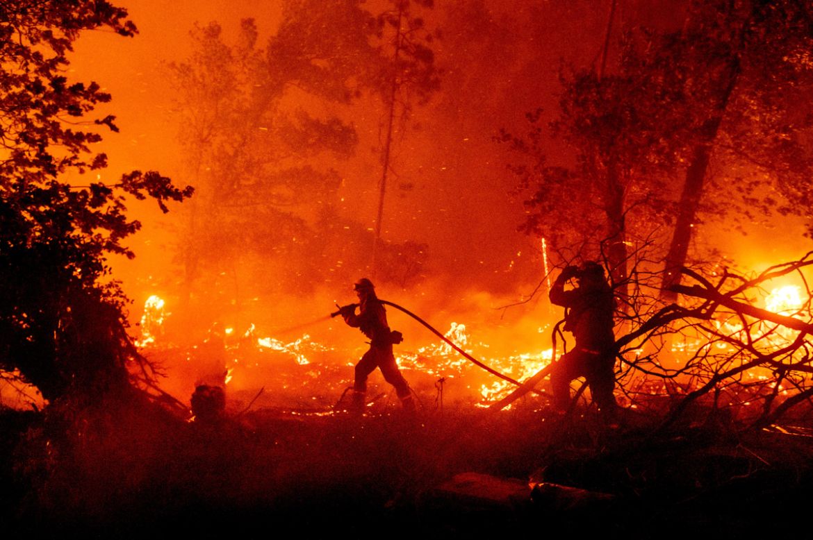 CORRECTS COUNTY TO MADERA COUNTY INSTEAD OF MARIPOSA COUNTY - Firefighters battle the Creek Fire as it threatens homes in the Cascadel Woods neighborhood of Madera County, Calif., on Monday, Sept. 7,