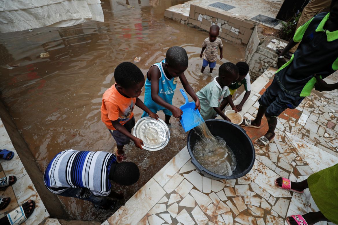 Children remove water from their flooded courtyard after heavy rains in the Ndiaga Mbaye district on the outskirts of Dakar, Senegal September 6, 2020.REUTERS/ Zohra Bensemra